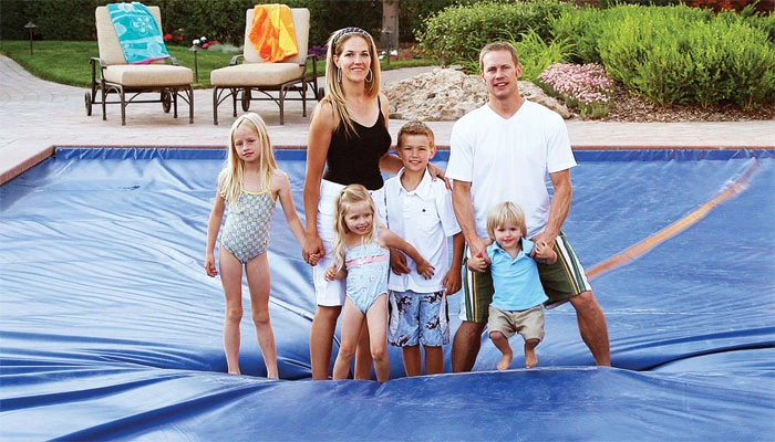 Coverstar demonstration showing a family on a closed pool cover