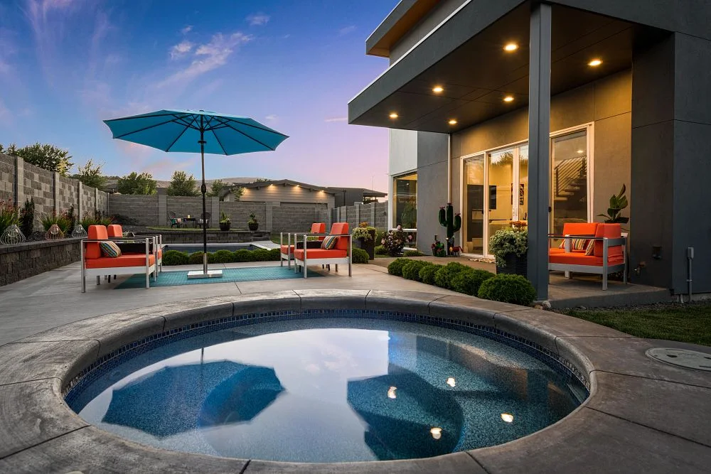 Shasta fiberglass spa beside a warmly lit patio at dusk